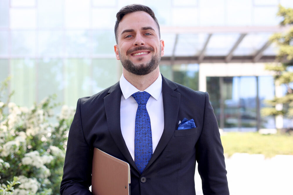 man in business casual shirt smiling